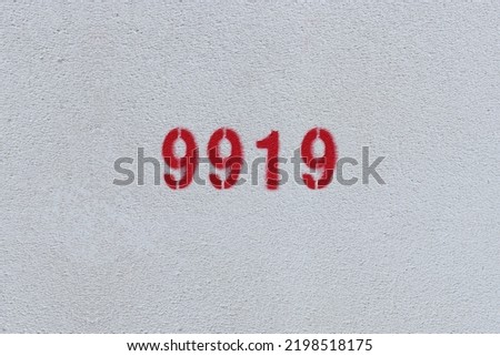Red Number 9919 on the white wall. Spray paint.
