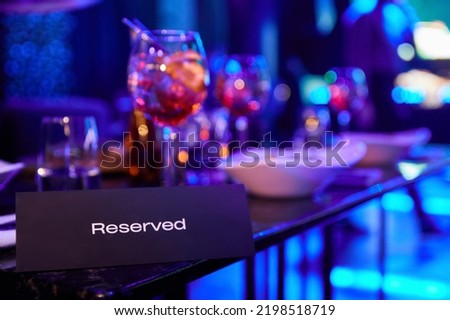 Reserved table in night club against the background of multi-colored spotlights