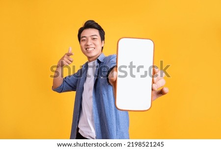 image of asian man holding phone, isolated on yellow background Royalty-Free Stock Photo #2198521245