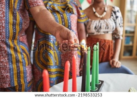 Close-up of African family burning seven candles for Kwanzaa holiday to celebrate it at home
