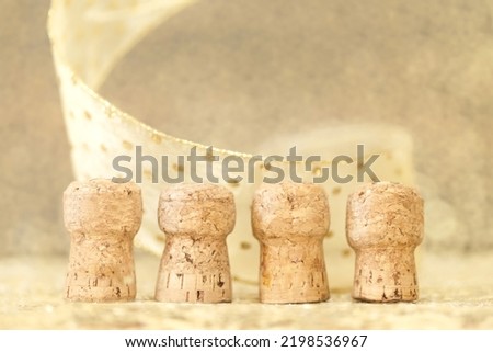New Year concept, corks from open champagne bottles, golden bokeh background
