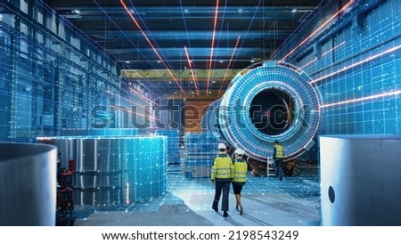 Futuristic Technology Concept: Team of Engineers and Professionals Workers in Heavy Industry Manufacturing Factory that is Digitalized with Graphics into Digital Twin of Industry 4.0 High Tech Royalty-Free Stock Photo #2198543249