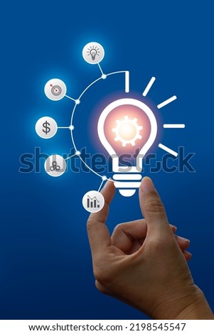Hand holding lightbulb and there is a gear icon new idea concept with innovation and inspiration, innovative technology in science and communication concept Royalty-Free Stock Photo #2198545547