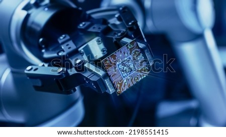 Futuristic Animation Concept: High-Tech Authentic Robot Arm Holding Contemporary Super Computer Processor Moving into Focus. CPU Microchip Digitilizes and Sends Data Power Lines with Computer Vision Royalty-Free Stock Photo #2198551415
