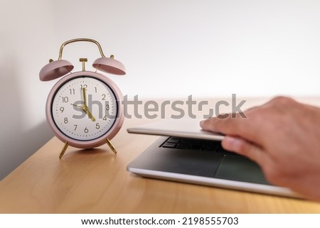 Closing the laptop at 5 p.m. Quiet quitting concept Royalty-Free Stock Photo #2198555703