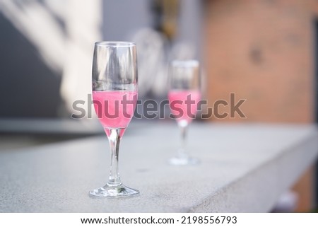 glass of pink champagne at bar