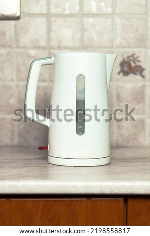 In a White Kettle for Boiling Water, Making Tea or Coffee, modern kitchen