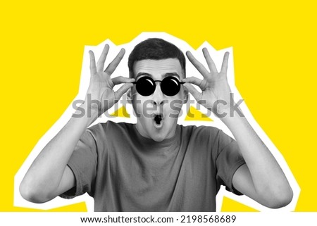 Excited young man in t-shirt touching his eyeglasses, mouth open, amazed guy looking at amazing offer or deal, yellow studio background, collage, black and white people on colorful backgrounds Royalty-Free Stock Photo #2198568689