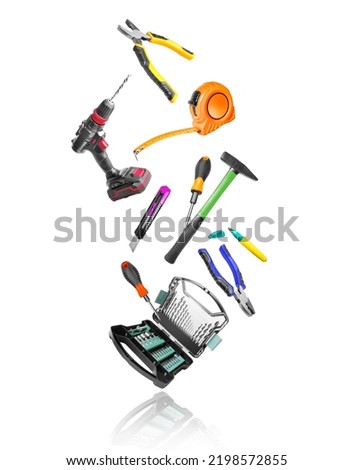 Various construction tools in the air on a white background Royalty-Free Stock Photo #2198572855