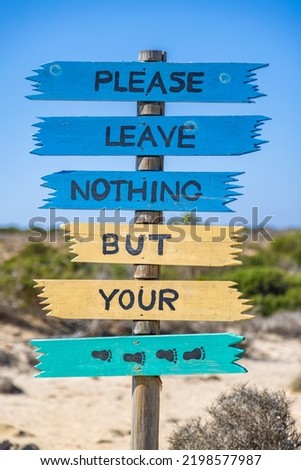 Colorful sign with message "Please leave nothing but your footprints" on Chrysi island, Crete, Greece