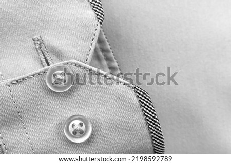 The sleeve of a men's shirt with buttons close-up. Black and white photography