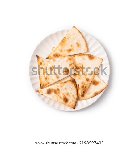 Pita bread sliced into triangles on White plate on white background, top view Royalty-Free Stock Photo #2198597493