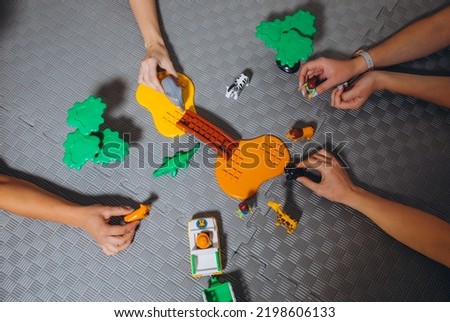 children's game with animal figurines, savannah, hands. High quality photo