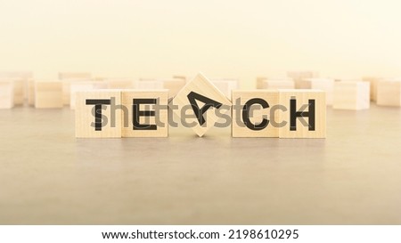 wooden blocks with the word TEACH on table