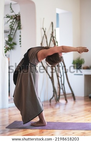 Yogi woman practicing yoga lesson, doing hastauttanasana or upward salute Royalty-Free Stock Photo #2198618203