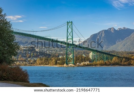 Lions Gate Bridge in summer day, Vancouver, BC, Canada. View of Lions Gate Bridge from Stanley Park. Built in the 1930s, Vancouver's Lions Gate Bridge spans across Burrard Inlet to the Northshore