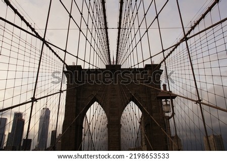 symmetrical view of the Brooklyn Bridge in New York city during sunset