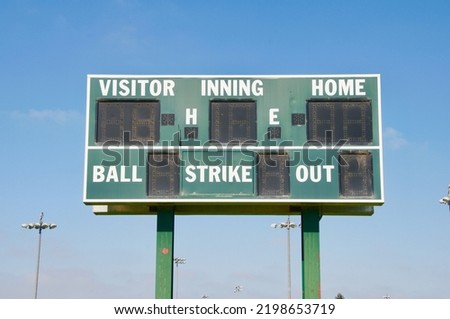 Baseball scoreboard green and white with blue sky Royalty-Free Stock Photo #2198653719