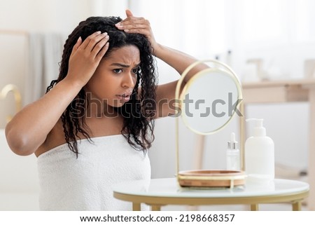Dandruff Problem. Upset African American Female Looking To Mirror At Her Hair Roots, Frustrated Young Black Woman Wrapped In Towel After Bath Suffering Dry Flaky Scalp, Closeup Shot With Free Space Royalty-Free Stock Photo #2198668357