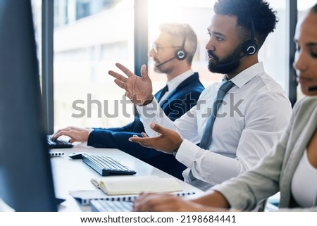 Call center, customer care and support with a man consultant in a headset working on a computer in his office. Contact us, crm and telemarketing with a male consulting on a call at his work desk Royalty-Free Stock Photo #2198684441
