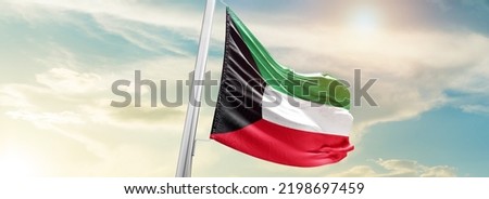 Kuwait national flag waving in beautiful sky. Royalty-Free Stock Photo #2198697459