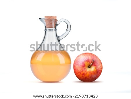 Transparent glass jug of organic apple cider vinegar isolated on white background. Anti inflammatory food Royalty-Free Stock Photo #2198713423