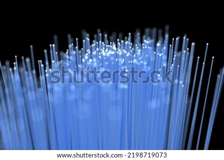 Defocused image of blue fiber optics against black background