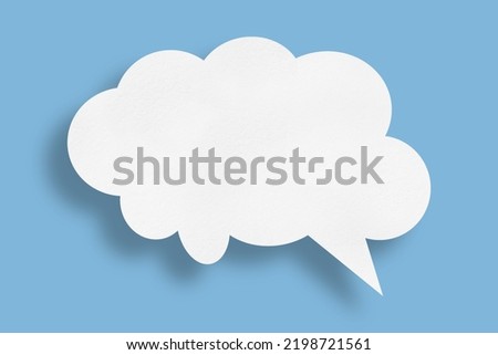 white cloud paper speech bubble shape against blue background design.