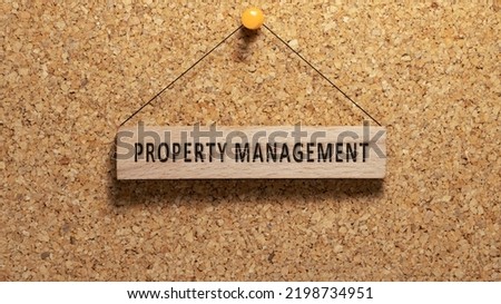 Property management word written on wooden surface. Hanging on wooden board