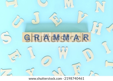 English grammar and learning class lesson. Wooden blocks typography word flat lay in blue background. Royalty-Free Stock Photo #2198740461