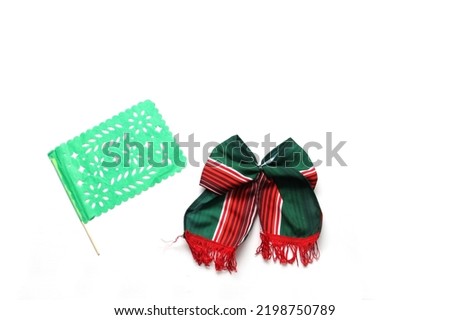 Decorative objects of Mexican party: pennants, green, white and red tricolor tie to celebrate Independence Day, Revolution and Day of the Dead in Mexico Royalty-Free Stock Photo #2198750789