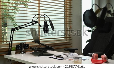 Home studio with professional condenser microphone, laptop and headphone. Entertainment, podcasts and technology concept
