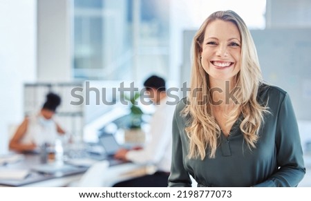 Female leader, manager or CEO with a smile, mission and vision in the office and her team in the background. Leadership, management and success with a woman boss and corporate business people at work