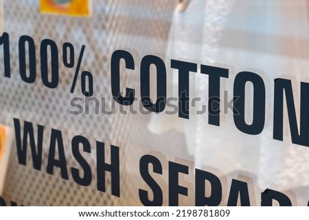 text 100 percent cotton writing on shop window.