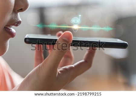 Close up of pretty woman holding in hand smart phone talking with digital assistant or friend distantly uses easy voice messaging, concept of modern ai technology, voice recognition, online translator Royalty-Free Stock Photo #2198799215