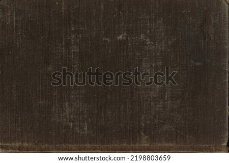 The texture of an old worn book binding is brown with faded places. An ancient worn-out book binding. The texture of the used, worn binding. Royalty-Free Stock Photo #2198803659