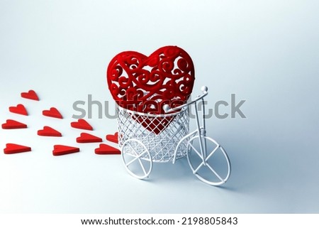 Shopping cart and decorative red hearts on a pastel blue background with a copy space. Valentine's Day, Mother's Day, Wedding