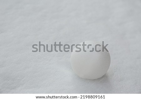 Perfect snowball on snow outdoors, closeup. Space for text