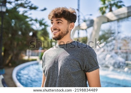 Young arab man smiling happy standing at the city. Royalty-Free Stock Photo #2198834489