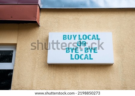 BUY LOCAL OR BYE - BYE LOCAL. White light advertising sign.