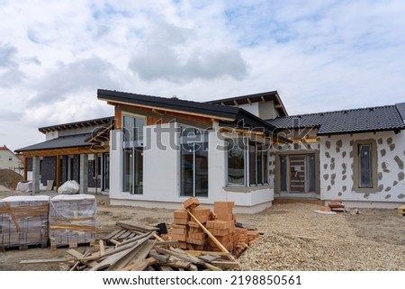 modern House under construction with polystyrene insulation almost ready . Royalty-Free Stock Photo #2198850561