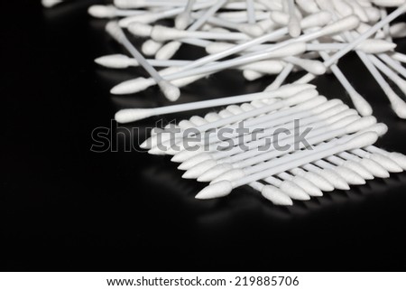 the cotton buds on black background