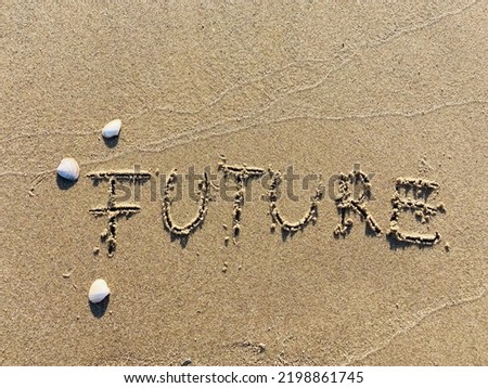 on the beach is carved with letters in the smooth sand the writing Future