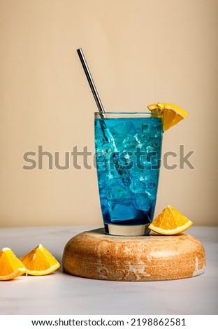 Blue Lagoon mojito-A mocktail drink which is soda and blue in colour served with ice cubes and fresh orange slices to give a slight tanginess. Royalty-Free Stock Photo #2198862581