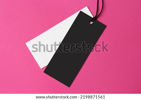 Tags with space for text on pink background, top view