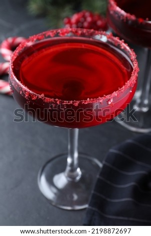 Delicious Christmas cocktail with liqueur on black table, closeup