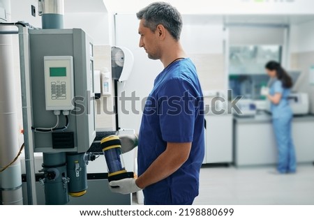 Laboratory assistant sends results of patient's lab tests to attending physician using pneumatic mail Royalty-Free Stock Photo #2198880699