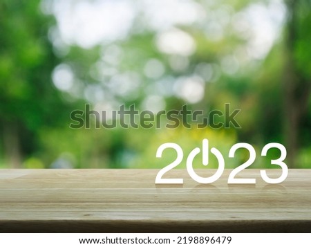 2023 start up business flat icon on wooden table over blur green tree in park, Happy new year 2023 cover concept