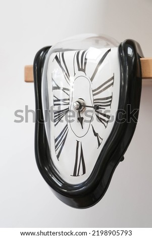 Decorative clocks drain off the shelf. The clock is a symbol of the impermanence of time. Theme is persistence of memory. Royalty-Free Stock Photo #2198905793