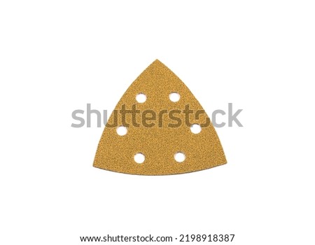 Yellow sandpaper in the shape of a triangle with round openings. Royalty-Free Stock Photo #2198918387